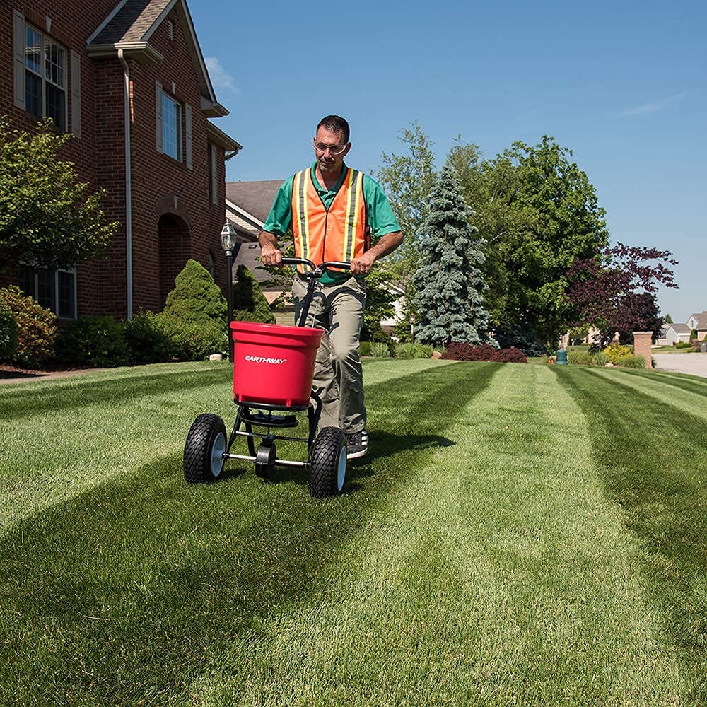EarthWay 2150 Commercial 50 LB Broadcast Fertilizer Spreader. Heavy-Duty Walk-Behind Push Garden Seeder with Adjustable Drop Rate and Driving Handle. Large 13 inch Pneumatic Stud Tires